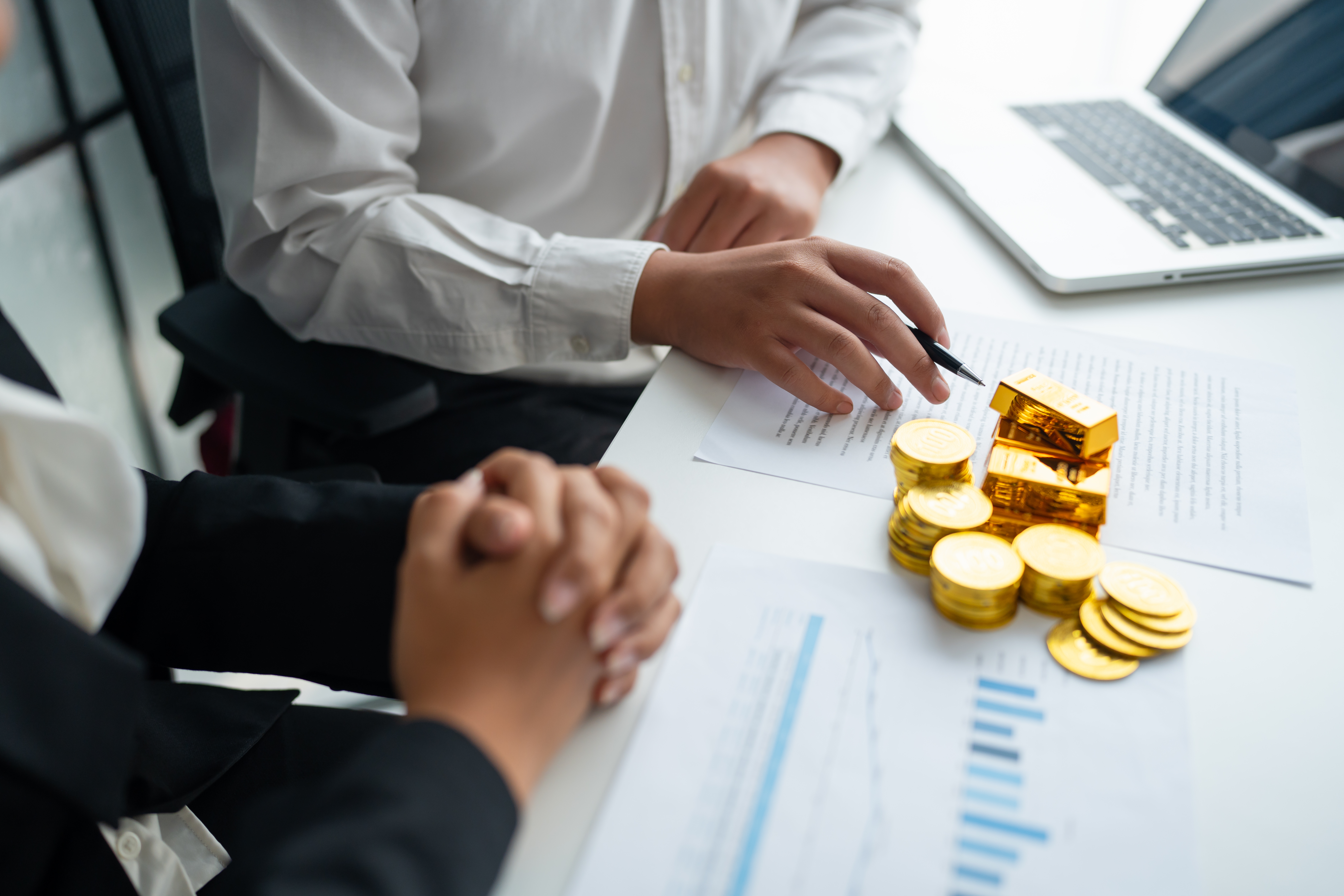 Gold bar Trading business people hand offering goldÂ Investment in gold mining company or Trading gold on the stock exchangeÂ Rising prices